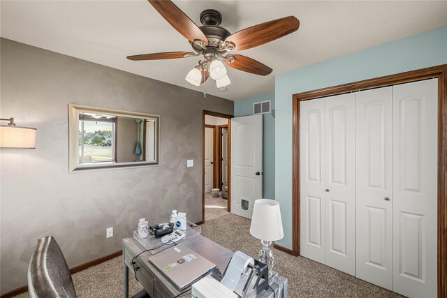 office space with ceiling fan and light colored carpet