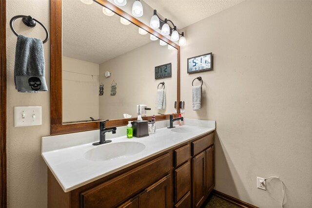 bathroom with vanity and a textured ceiling