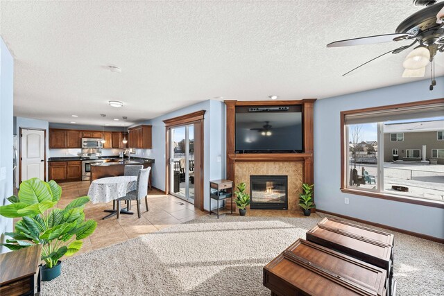 living room with light tile patterned floors, a textured ceiling, and plenty of natural light