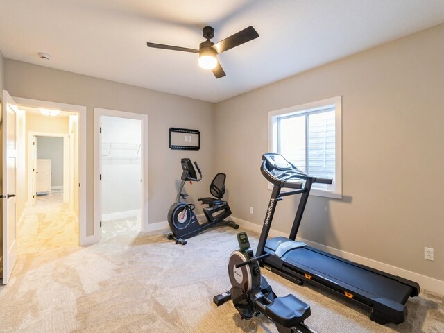 workout room featuring light colored carpet and ceiling fan