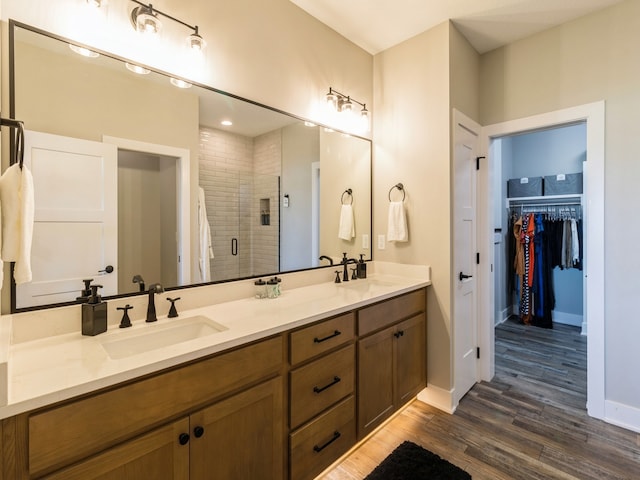 bathroom featuring a shower with door, hardwood / wood-style flooring, and vanity