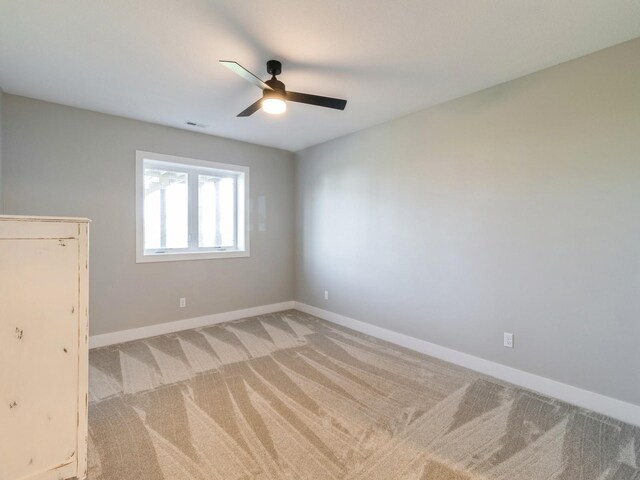 unfurnished bedroom featuring ceiling fan and carpet