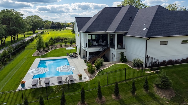 view of pool with a lawn and a patio area