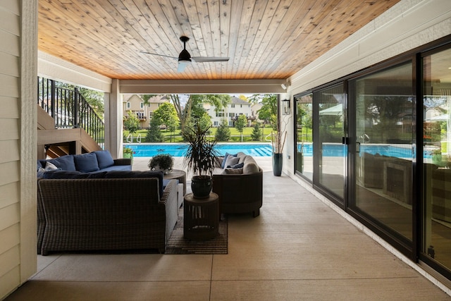 sunroom / solarium featuring ceiling fan and wooden ceiling