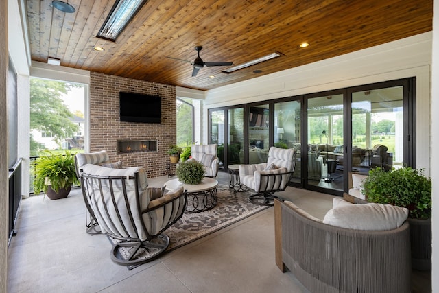 view of patio featuring a fireplace and ceiling fan