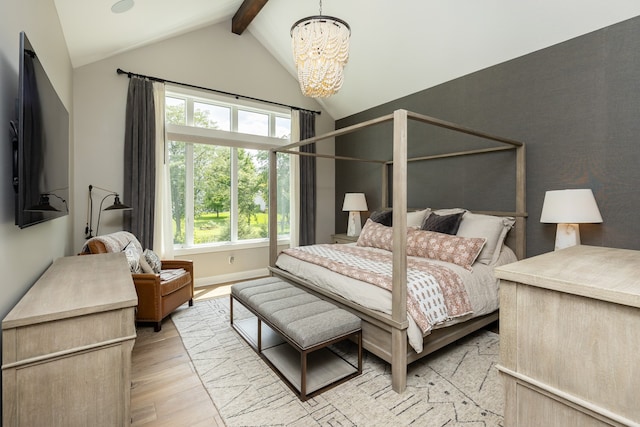 bedroom with lofted ceiling with beams, a chandelier, and light hardwood / wood-style floors