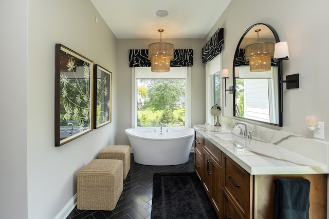 bathroom featuring vanity, a bath, and a wealth of natural light