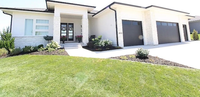 view of front facade with a garage and a front lawn