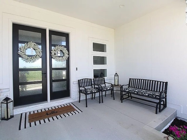 doorway to property with an outdoor hangout area and a patio