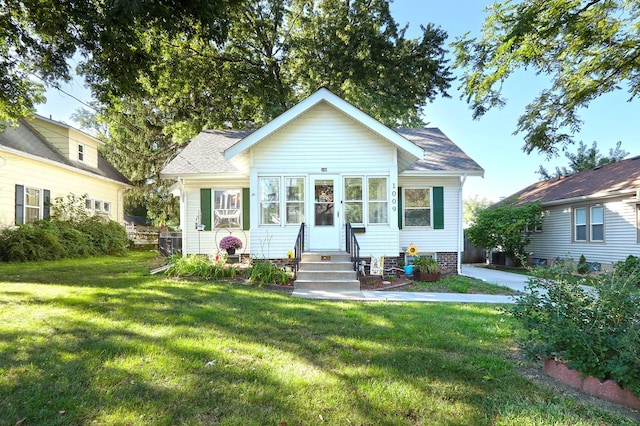 bungalow-style home with a front lawn