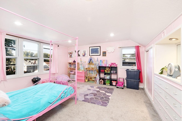 carpeted bedroom with multiple windows and vaulted ceiling