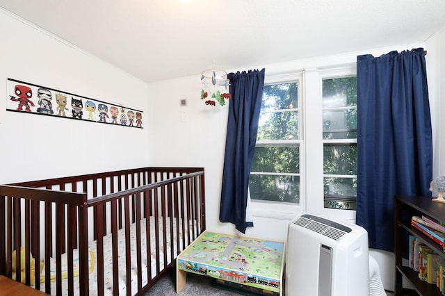 bedroom featuring a nursery area