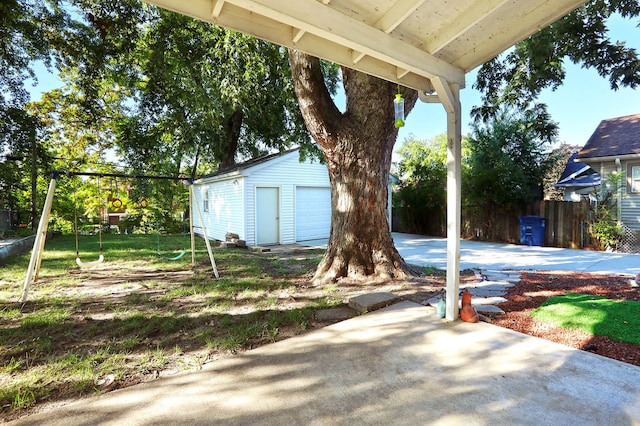 view of yard featuring a garage and an outbuilding