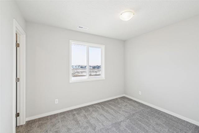 spare room featuring light colored carpet