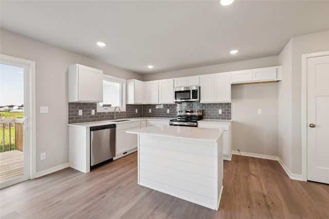 805 3rd St NW, Bondurant, IA 50035 - kitchen with stainless steel appliances, white cabinetry, decorative backsplash, and recessed lighting