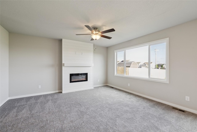 805 3rd St NW, Bondurant, IA 50035 - unfurnished living room with carpet, a fireplace, and ceiling fan