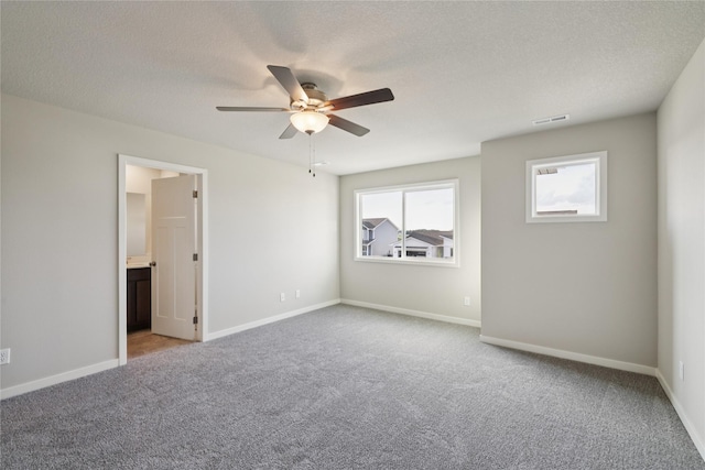 805 3rd St NW, Bondurant, IA 50035 - unfurnished bedroom with carpet flooring, a textured ceiling, ceiling fan, and ensuite bath