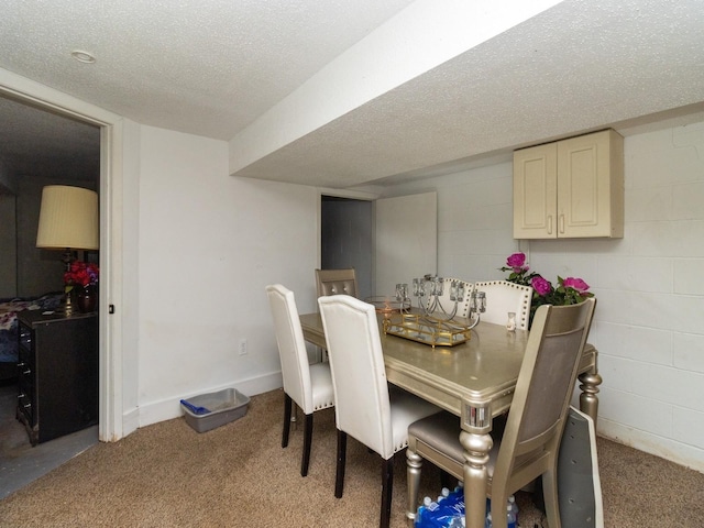 dining room featuring carpet floors and a textured ceiling