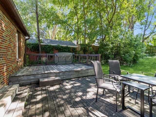 5820 Urbandale Ave, Des Moines, IA 50322 - wooden deck featuring a fenced backyard, outdoor dining space, and area for grilling