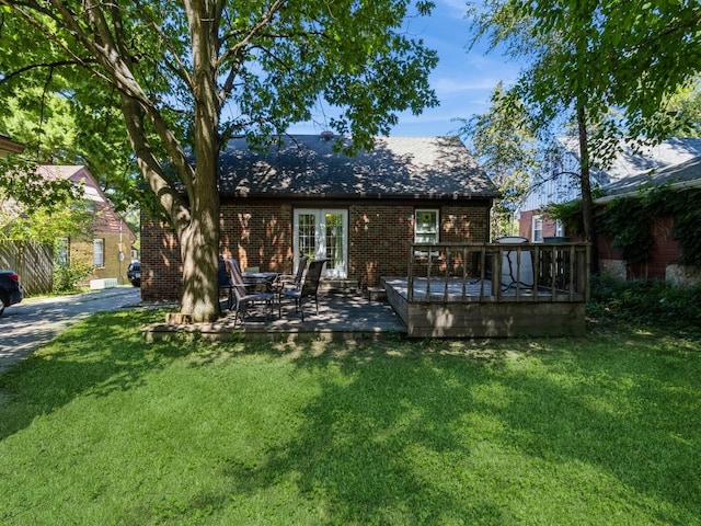 back of house with a yard and a wooden deck