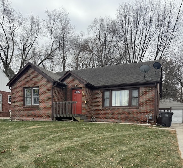 view of front of house featuring an outbuilding, a front lawn, and a garage