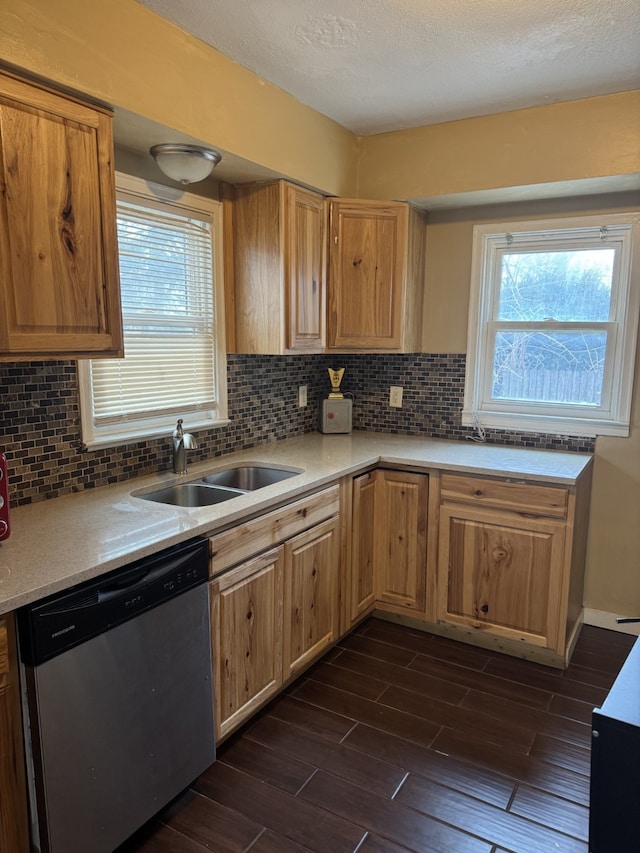 kitchen with dishwasher, backsplash, dark wood-type flooring, and sink