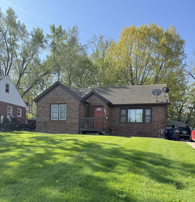 5820 Urbandale Ave, Des Moines, IA 50322 - view of front of house featuring brick siding and a front lawn