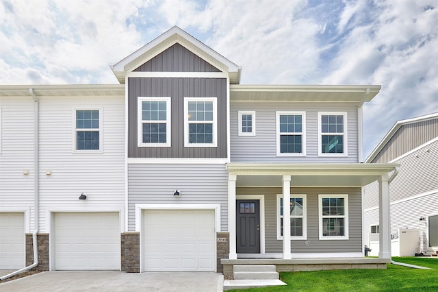 townhome / multi-family property featuring covered porch and a garage