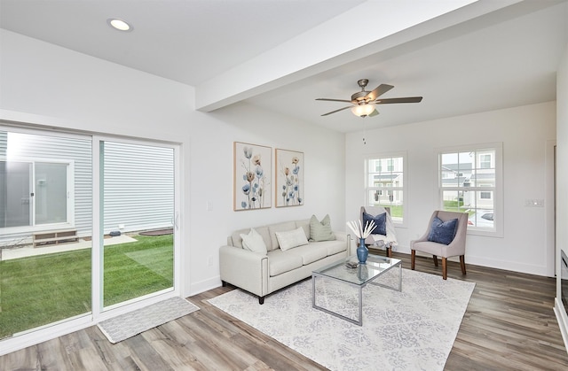 living room with beam ceiling, dark hardwood / wood-style flooring, and ceiling fan