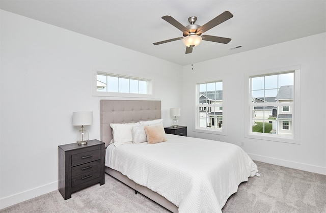 bedroom featuring ceiling fan and light carpet