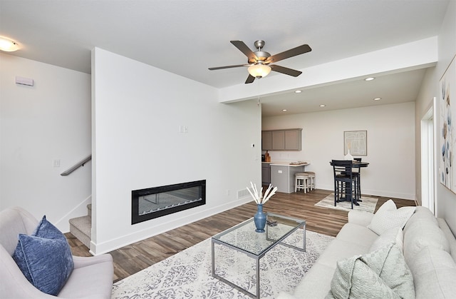 living room with hardwood / wood-style floors and ceiling fan