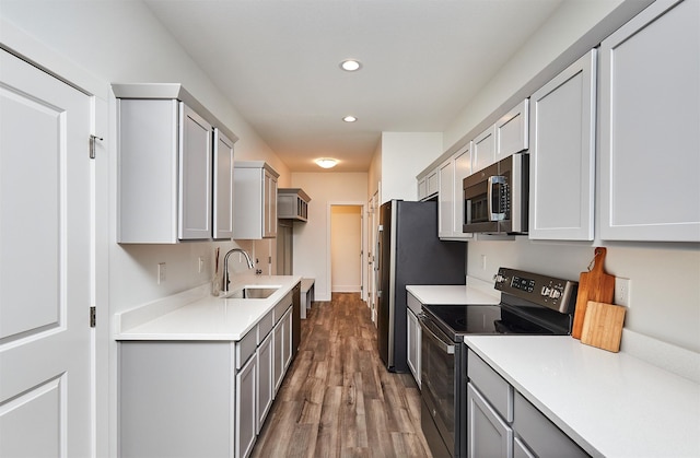 kitchen featuring gray cabinetry, sink, stainless steel appliances, and dark hardwood / wood-style floors