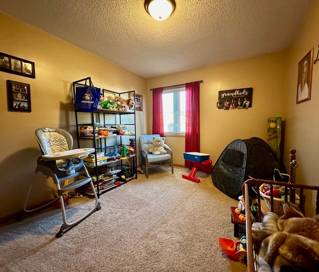 rec room featuring carpet and a textured ceiling