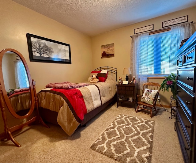 bedroom featuring carpet flooring and a textured ceiling