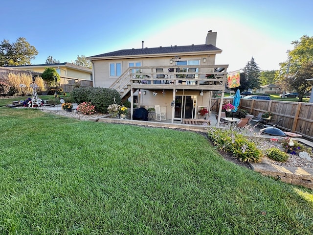 back of house with a patio area, a yard, and a deck