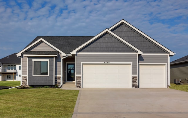 craftsman-style house featuring a garage and a front yard