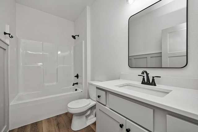 full bathroom featuring wood-type flooring, vanity, shower / bath combination, and toilet