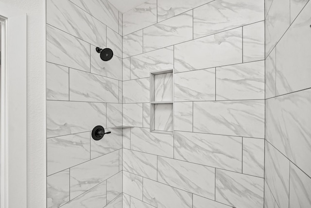 bathroom with a tile shower