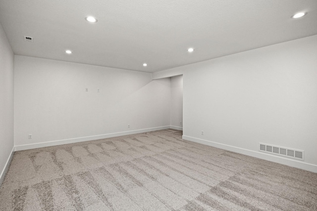 unfurnished room with light colored carpet