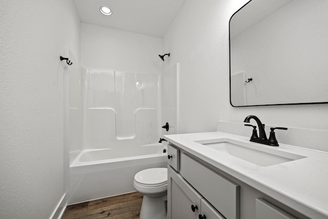 full bathroom featuring vanity, hardwood / wood-style flooring, toilet, and shower / bathtub combination