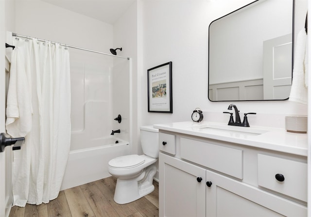 full bathroom featuring hardwood / wood-style floors, vanity, toilet, and shower / tub combo