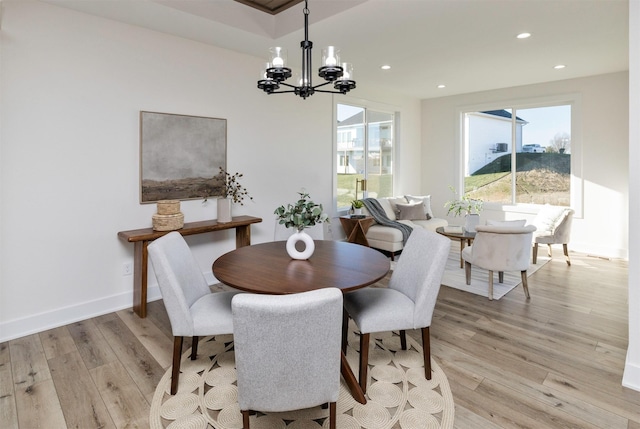 dining area with a chandelier and light wood-type flooring