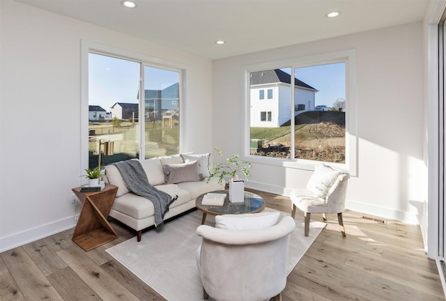 sitting room with a healthy amount of sunlight and light hardwood / wood-style floors