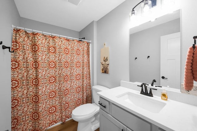 bathroom featuring vanity, hardwood / wood-style flooring, and toilet