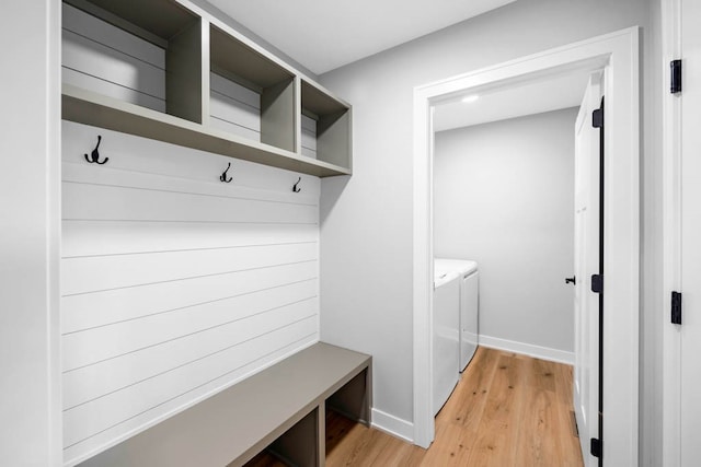 mudroom featuring light wood-type flooring and washing machine and clothes dryer