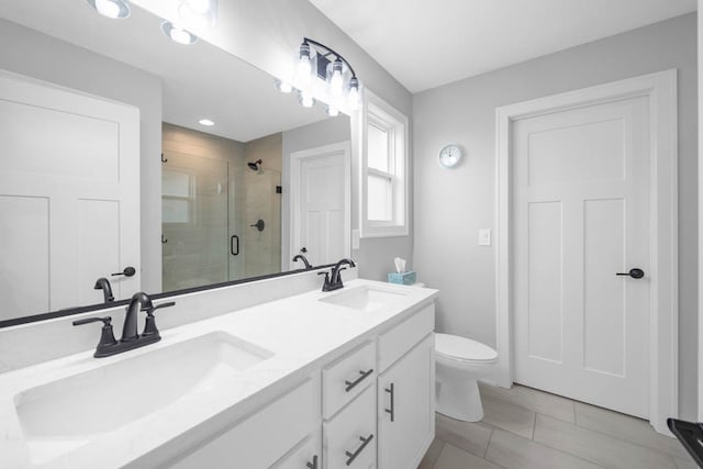 bathroom with tile patterned floors, vanity, toilet, and walk in shower