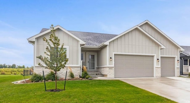 view of front of home with a front yard and a garage