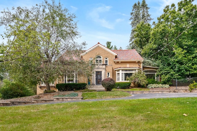 mediterranean / spanish home with a front yard