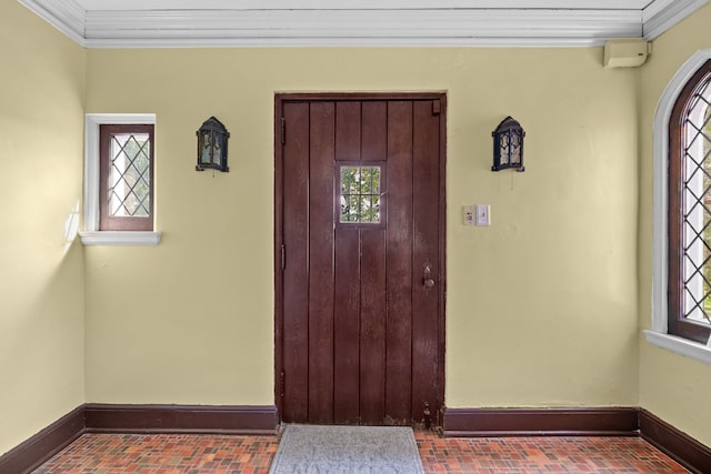 entryway featuring crown molding