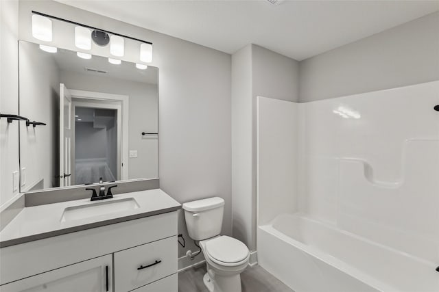 full bathroom with washtub / shower combination, vanity, and toilet